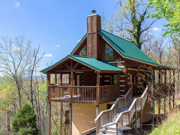 A cabin with a balcony, a staircase, and a chimney. - Sweet Surrender by Jackson Mountain Rentals (Gatlinburg)