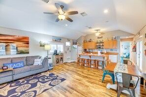 Cozy living area with a sofa, dining table, and kitchenette.