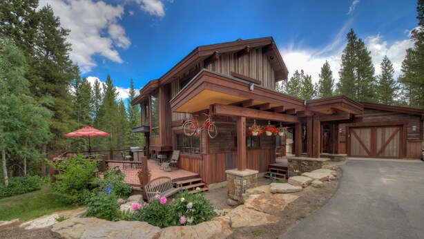 A rustic cabin with a covered porch, stone steps, and a garage. - The Breckenridge Bicycle House - One Mile to Main St and the gondola (Breckenridge)