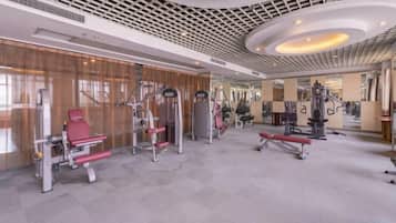 A gym with various exercise equipment, including treadmills and weight machines.