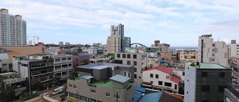 A cityscape with various buildings, including a prominent hotel with a sign.