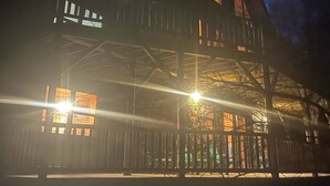 A two-story wooden house with large windows and a balcony. - Spacious 8-Bedroom Retreat at Martinwoods Cabins, Perfect for family gatherings (Rockbridge)
