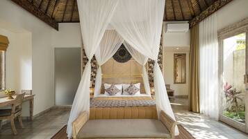 A bed with a canopy, a dining table, and a view of the outdoors.