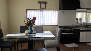A modern kitchen with a dining area. - Bonel Guest House (Tomisato)