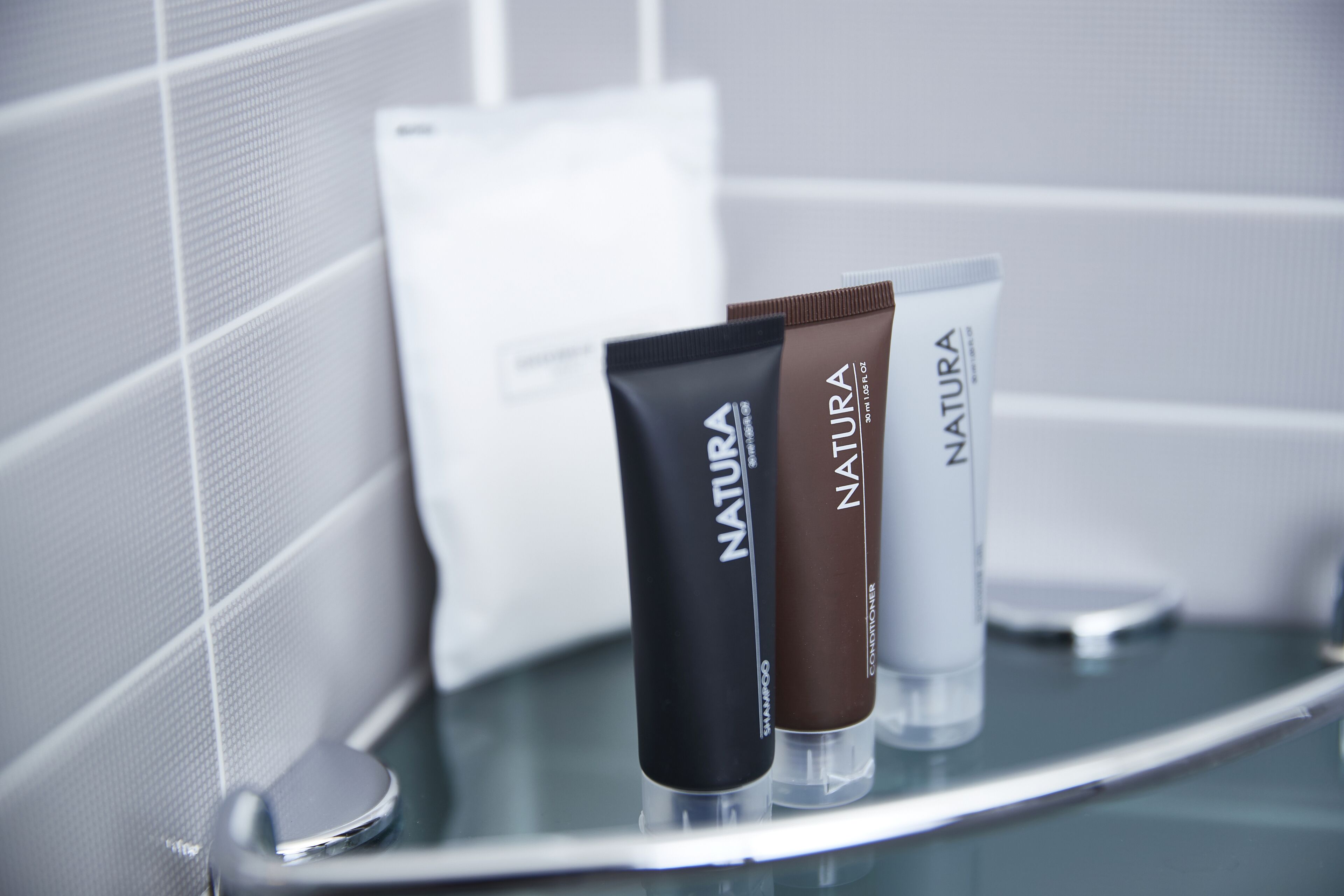 designer toiletries, hair dryer, bathrobes, slippers