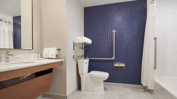 Un baño moderno con lavamanos blanco, inodoro y bañera.