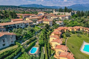 Un quartier résidentiel avec des maisons, une piscine et, au loin, un château.