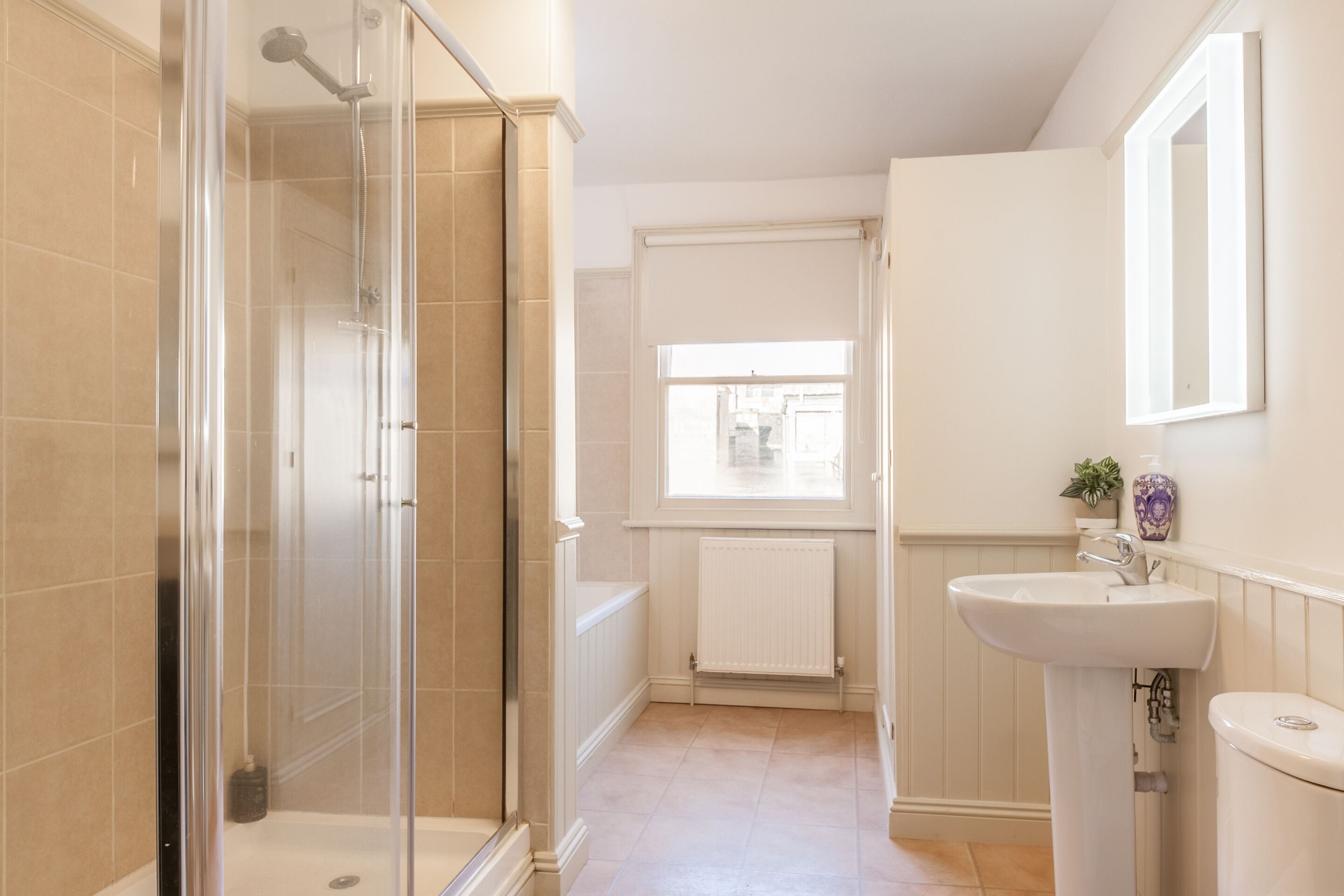 Bathtub, rainfall showerhead, hair dryer, towels