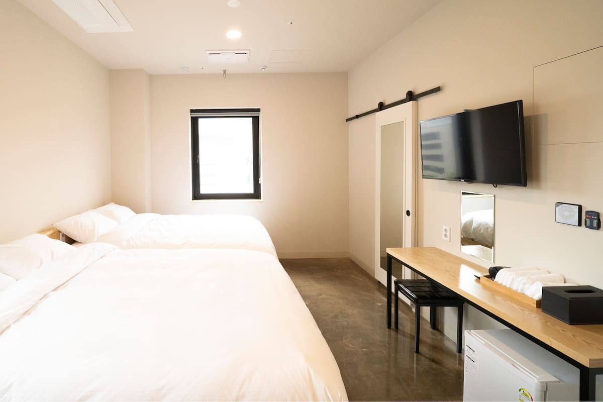 Premium bedding, pillow-top beds, desk, laptop workspace