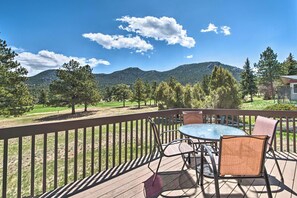 A deck with a table and chairs, overlooking a mountainous landscape. - Fireplace & Mtn Views: Estes Park Home w/ Deck! (Estes Park)