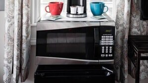 A kitchen area with a coffee maker, a microwave, and a toaster. - Charming Suite in the Heart of Charleston (Charleston)