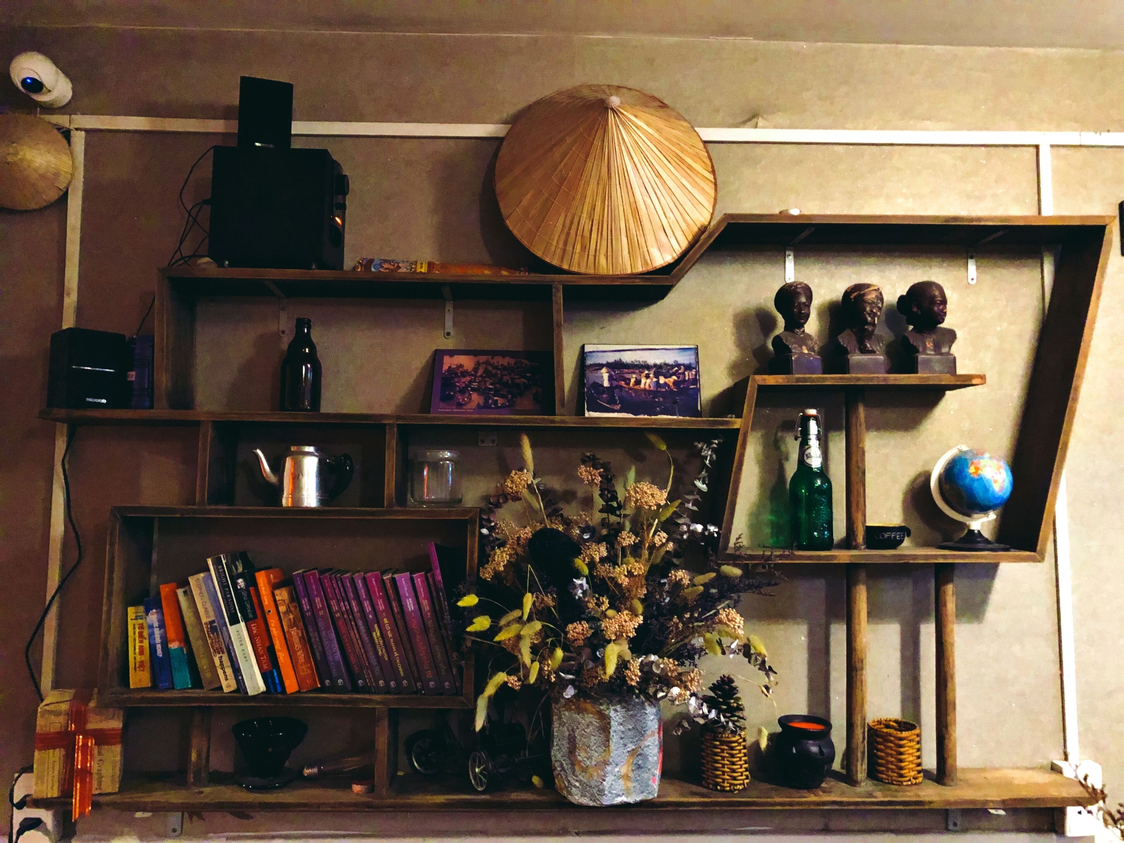 A bookshelf with books, a globe, and decorative items.