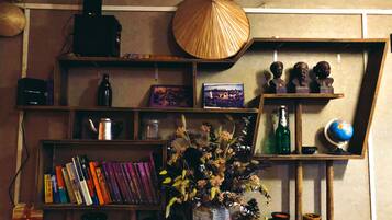 A bookshelf with books, a globe, and decorative items.