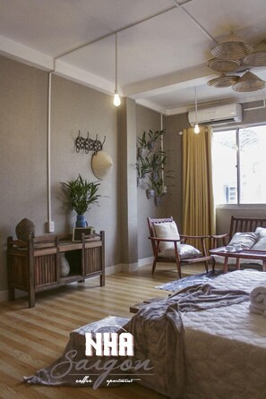 A spacious living room with a large bed, wooden furniture, and a window with curtains. - Nha Saigon (Ho Chi Minh City)