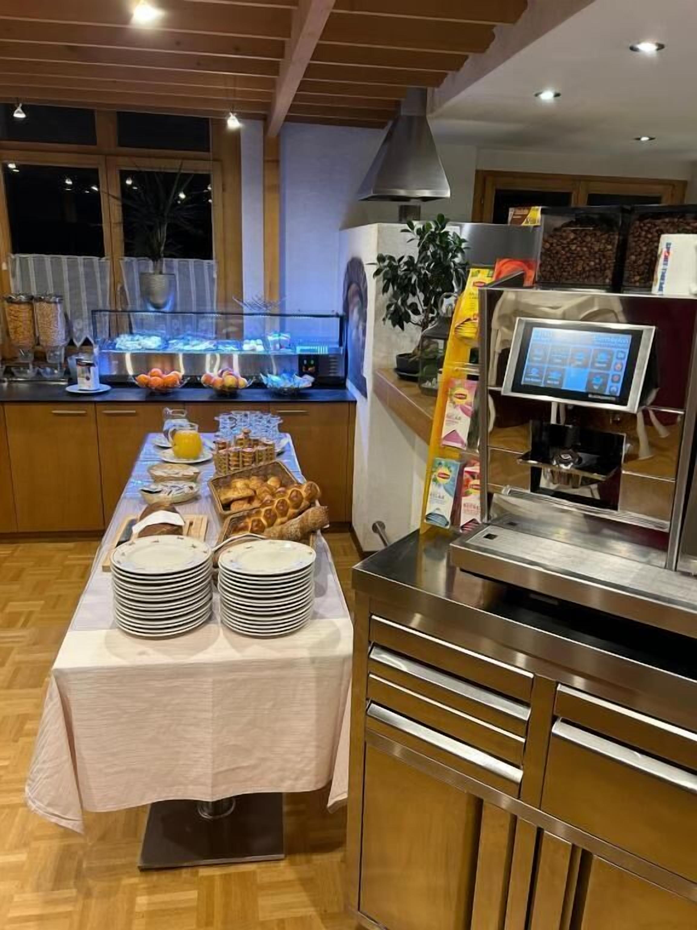 A buffet setup with a variety of food items and a self-service beverage station.