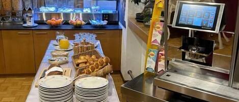 A buffet setup with a variety of food items and a self-service beverage station.