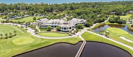 A large, single-story house with a wrap-around porch and a circular driveway.