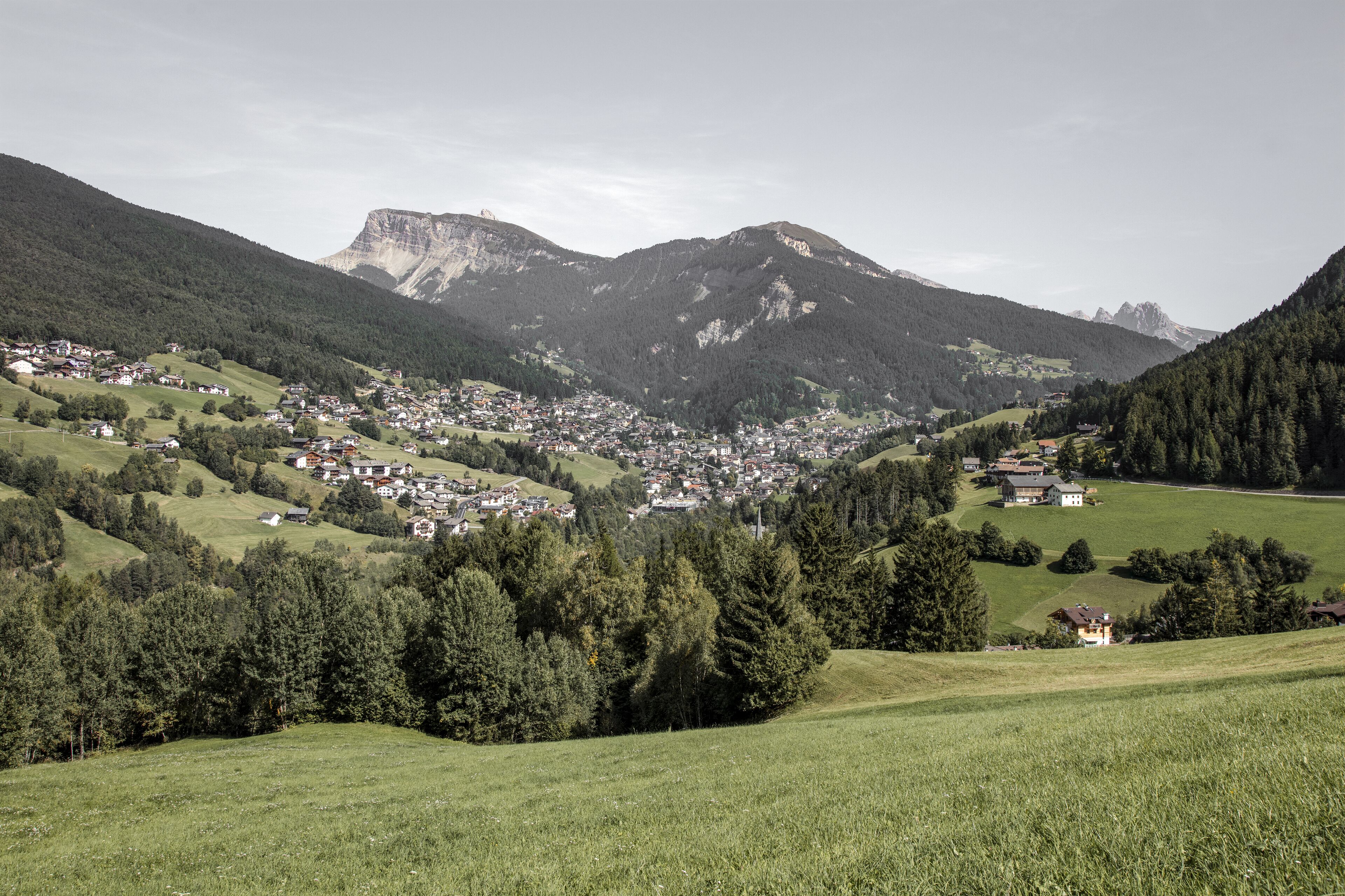 A mountainous landscape with a small town nestled in the valley.