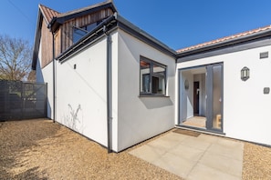 Stylish single-story residence with a red-tiled roof and a clean, inviting entrance.