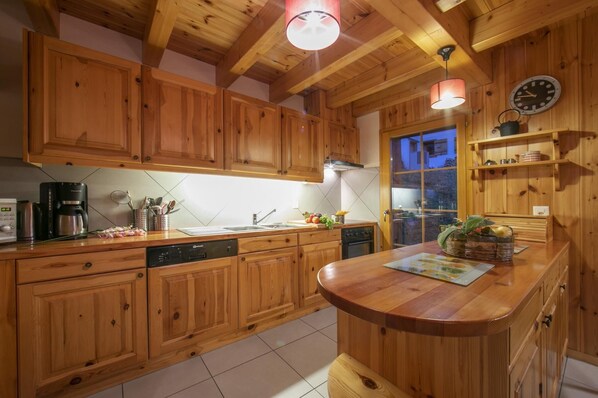 Enjoy cooking in this well-equipped kitchen with a central island, dishwasher, and stove.