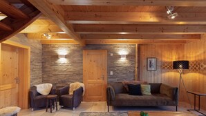 A cozy wooden interior with a stone wall, two sofas, a coffee table, and a lamp. - Chalet Belle Roche Recently Renovated Jacuzzi (Riddes)