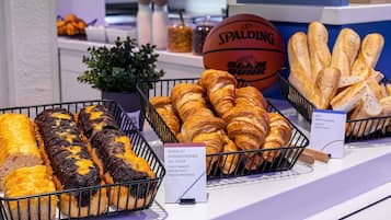 A bakery display with various baked goods, including bread and pastries.