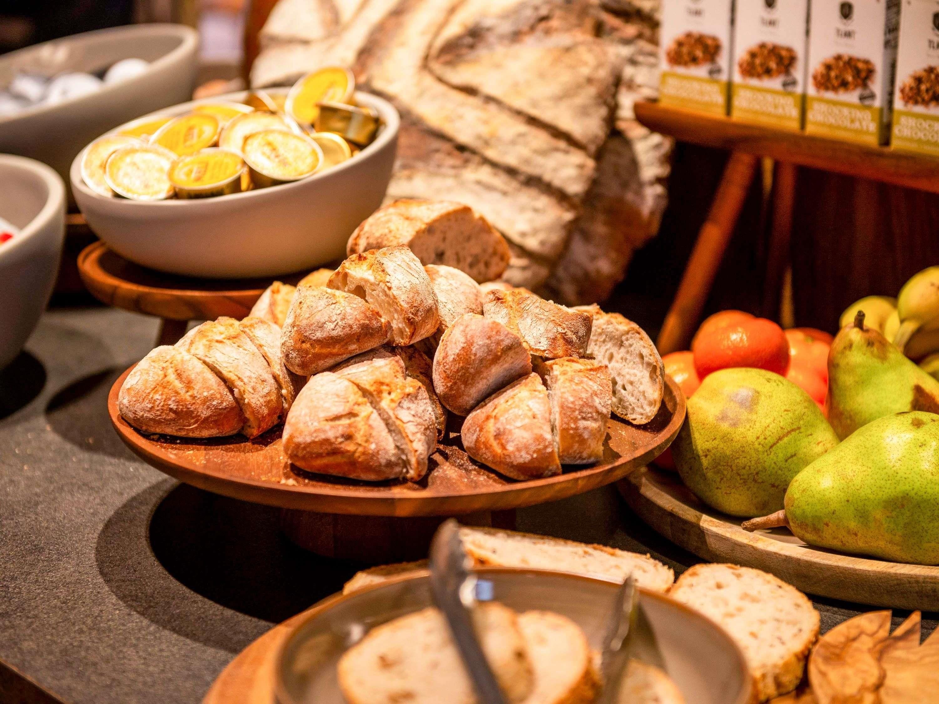 Ein reichhaltiges Buffet mit Brot, Obstscheiben und einem Brotlaib.