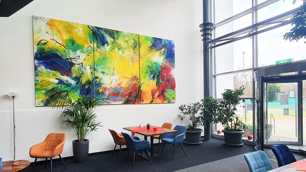 A modern interior with a large abstract painting, comfortable seating, and large windows. - Sport Hotel Kenzingen (Kenzingen)