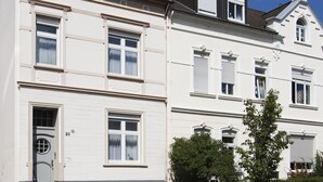 A multi-story building with a traditional architectural style, featuring symmetrical windows and a central entrance. - Vacation apartment Ahr-Flair (Bad Neuenahr-Ahrweiler)
