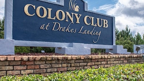 Welcome to the Colony Club at Drakes Landing, featuring a distinctive sign with the club's name in gold lettering.