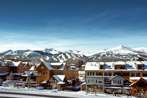 Experience the charm of a mountain town with traditional wooden buildings and stunning mountain views.