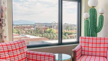 Room, 1 King Bed, Mountain View (Graduate) | Living area | 49-inch LCD TV with cable channels, TV