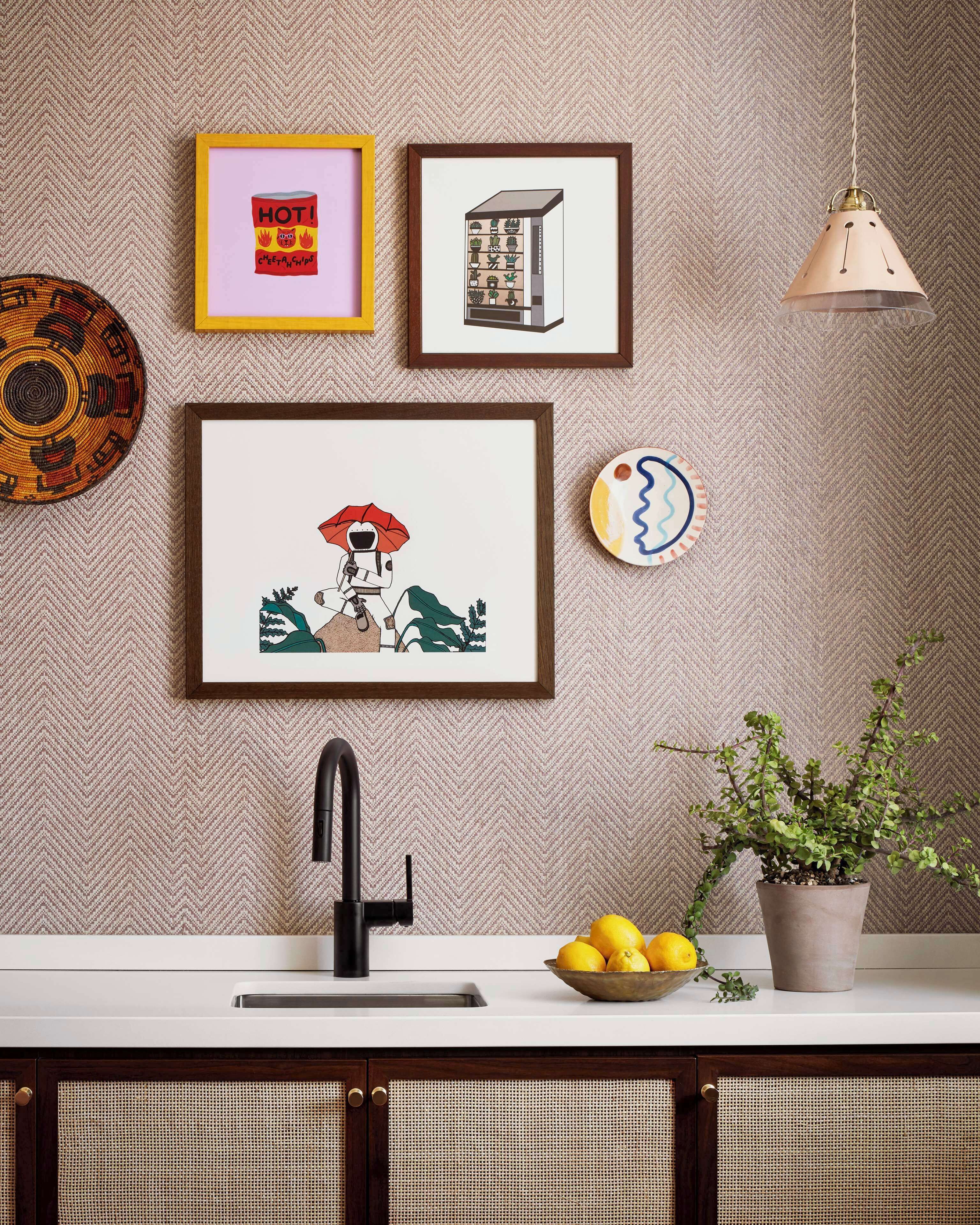 A kitchen with a modern sink, a potted plant, and a bowl of lemons.