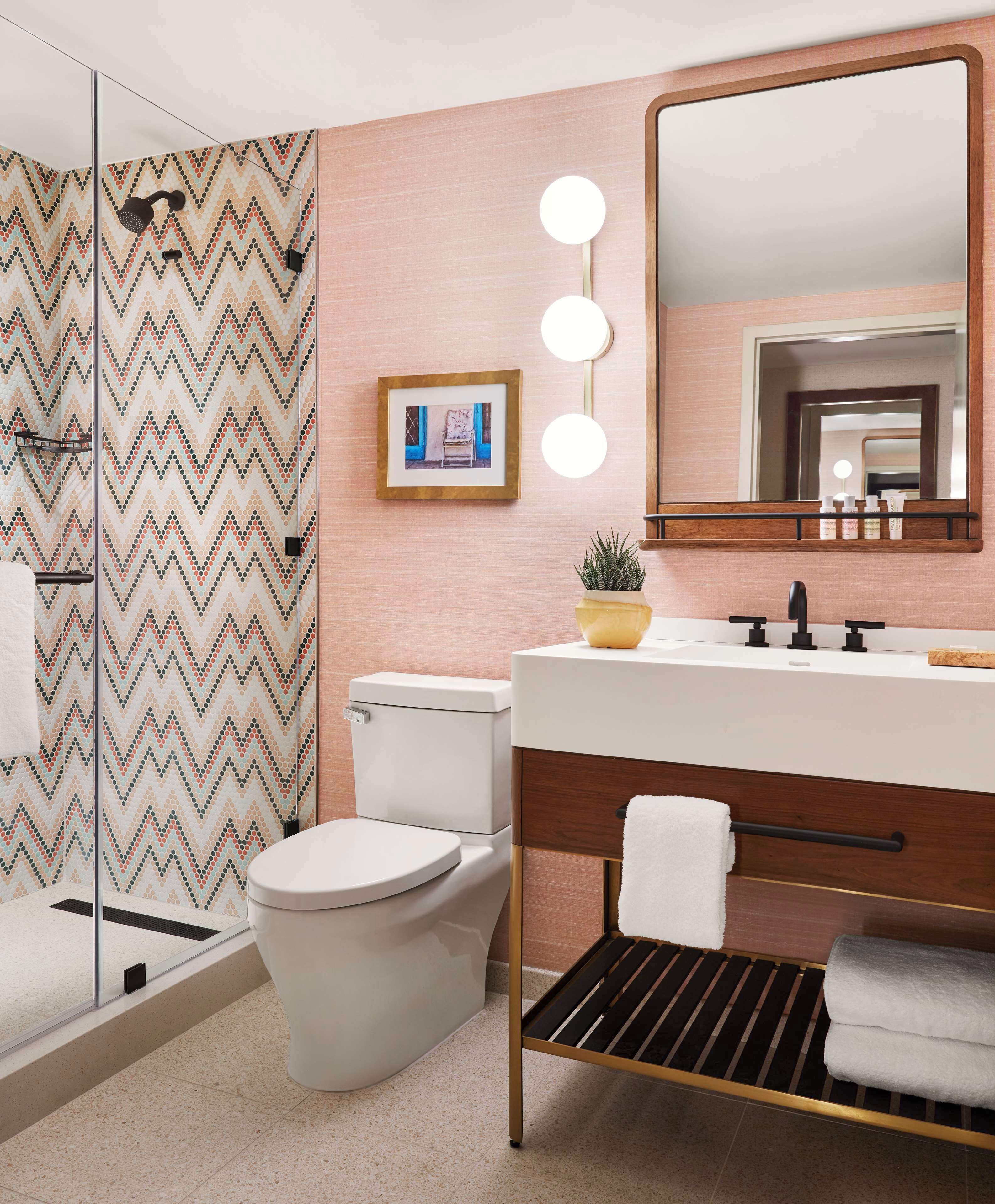 combined shower/bathtub, designer toiletries, hair dryer, towels