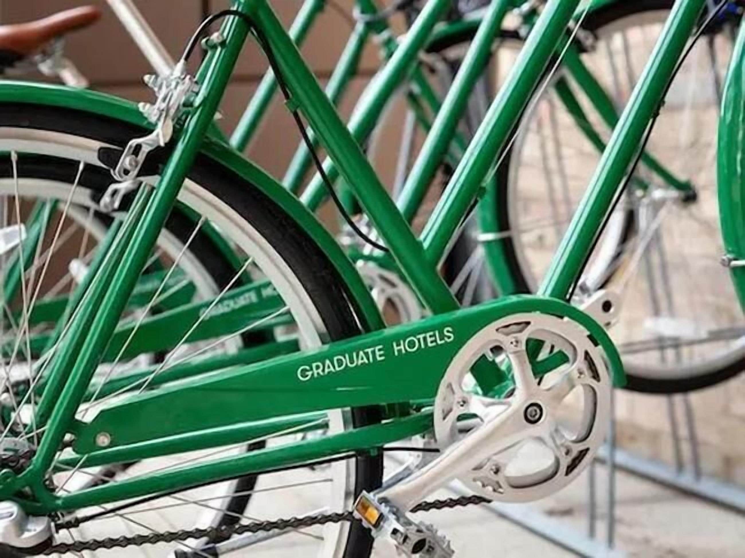 A green bicycle with 'GRADUATE HOTELS' written on the frame.