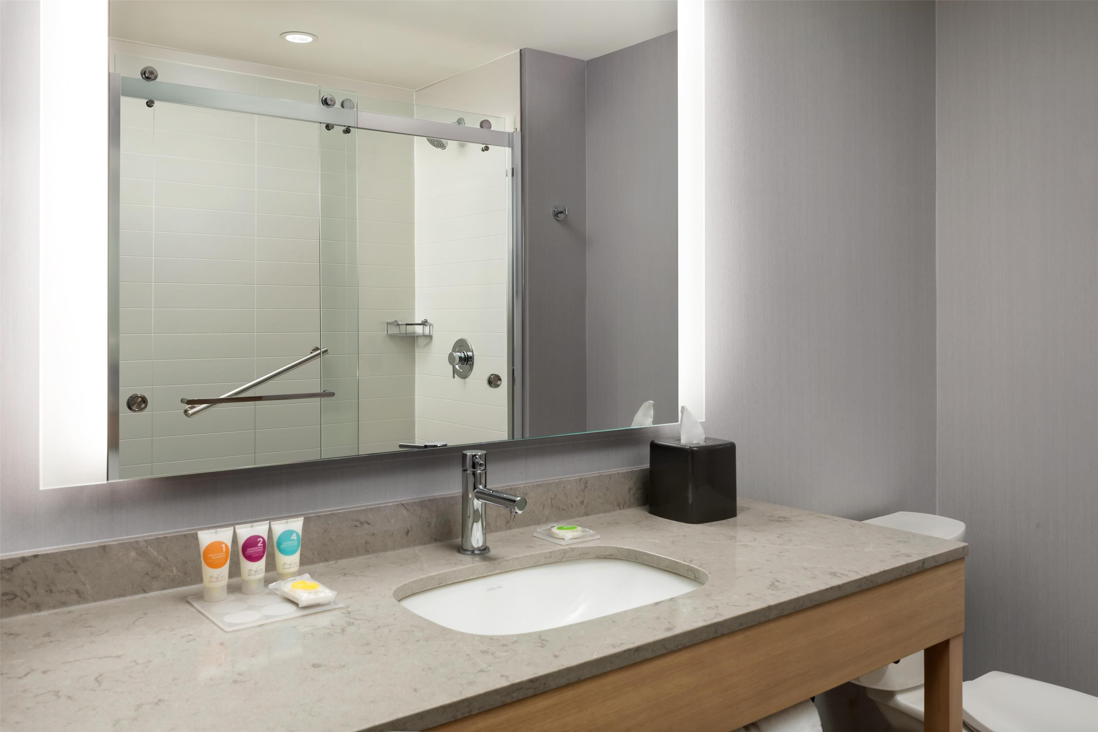 designer toiletries, hair dryer, towels