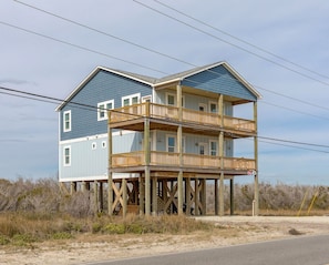 A two-story house with a balcony on the second floor.