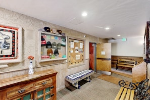 Relax in the hotel lobby, where a cozy bench and patterned table runner invite you to unwind.