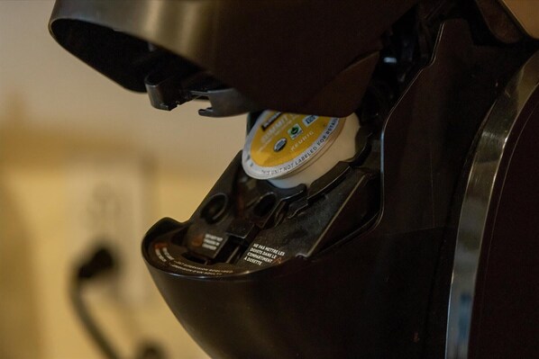 A close-up of a coffee machine with a label that reads 'REUSABLE' and 'NOT LABELED FOR RESIDENCE.'