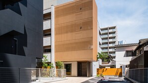 Un bâtiment moderne doté d’une façade originale, caractérisée par une combinaison de lignes verticales et horizontales.