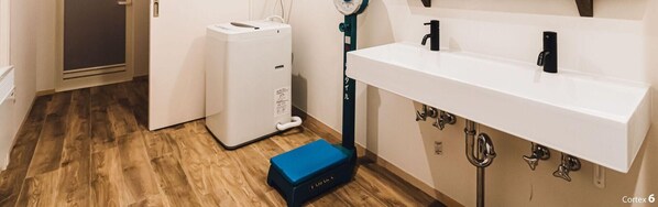 A compact kitchen with a white sink, a built-in stove, and a compact refrigerator. - Yamahana Onsen Tondenyu Ryokan (Sapporo)