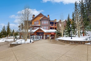 Stunning traditional architecture with a covered porch and scenic surroundings.