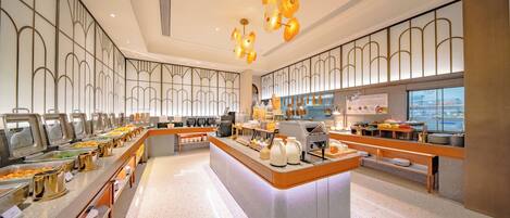 A buffet setup with multiple food stations, a central serving area, and a modern interior design.