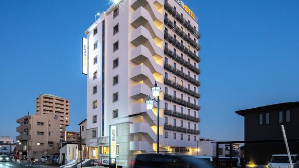 A multi-story hotel with a prominent 'Super Hotel' sign, featuring balconies on each floor and a modern architectural design. - Super Hotel Anjo (Anjo)