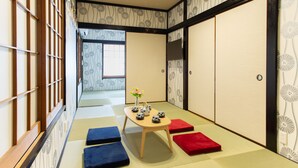 A traditional Japanese room with tatami flooring, a low wooden table with tea sets, and shoji screens. - My Home in Tokyo (Tokyo)