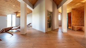 A spacious interior with wooden floors, high ceilings, and a central column. - Villa Balen (Benkovac)