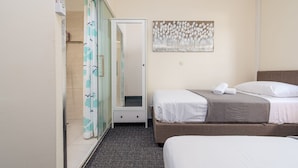 A hotel room with a bed, a bedside table, a mirror, a shower area, and a wall-mounted artwork. - Villa Dandelion (Benkovac)
