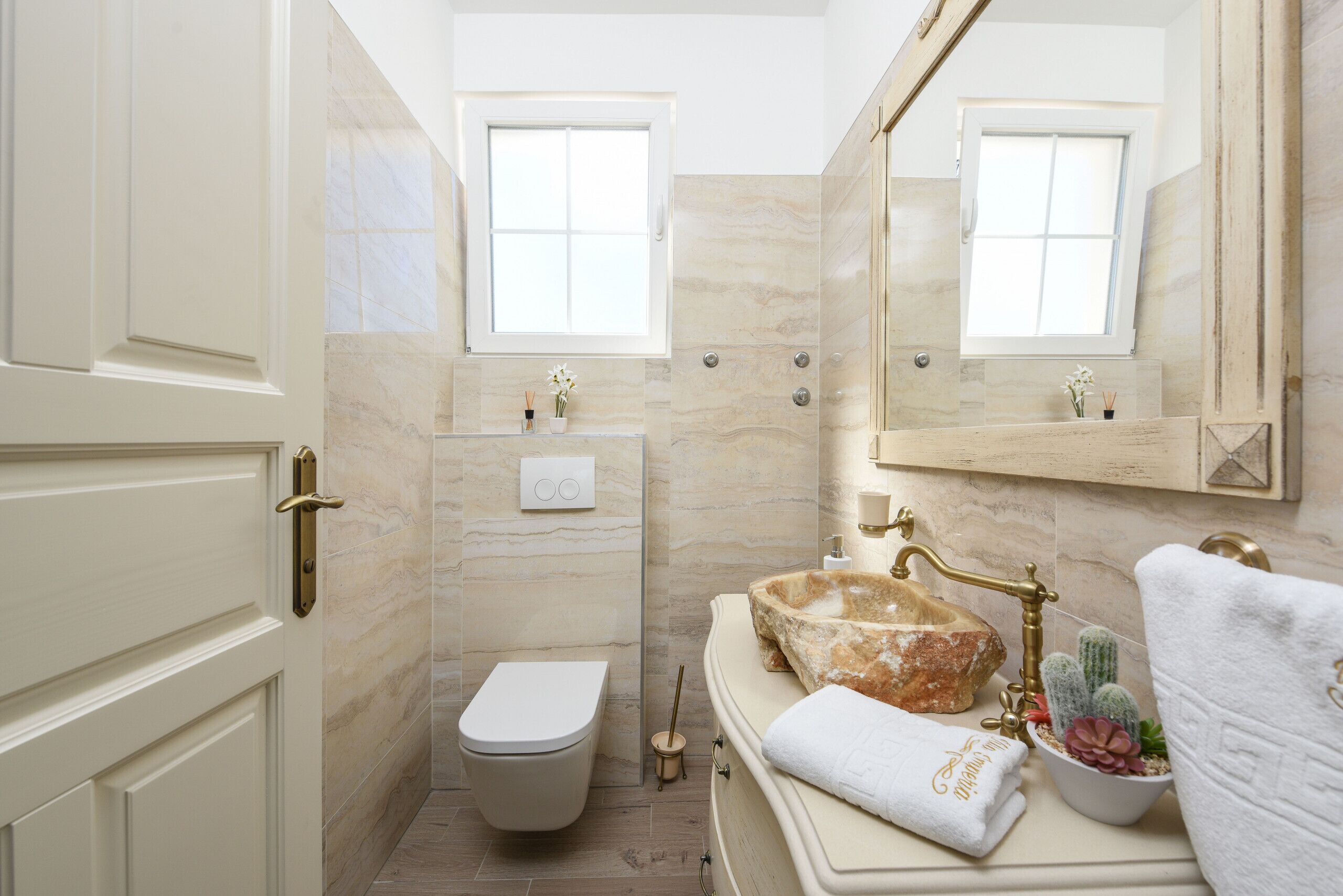 Une salle de bain avec des toilettes, un lavabo et un miroir.