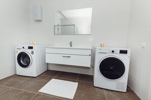 Suite Deluxe | Baño | Regadera, pantuflas, toallas 