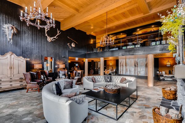 Experience the grandeur of this elegantly designed room, featuring a chandelier, seating area, and fireplace.